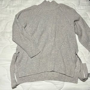 Turtleneck with side ties and stitching detail